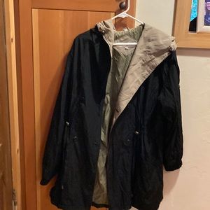 Stylish black rain coat with a hood and cute drapery in the back